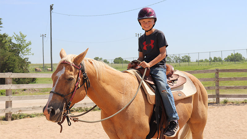 Image of a young rider on horseback
